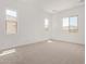 Spacious bedroom features neutral carpet, three large windows that provide ample natural light at 15833 W Bronco Trl, Surprise, AZ 85387