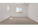 Neutral carpet in this large bedroom with a big window bringing in natural light at 15833 W Bronco Trl, Surprise, AZ 85387