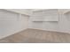 Walk in closet with carpeted floors and white storage shelves at 15833 W Bronco Trl, Surprise, AZ 85387
