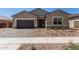 Charming single-story home featuring a two-car garage and desert landscaping at 15833 W Bronco Trl, Surprise, AZ 85387