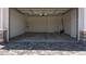 Spacious two-car garage with an automatic door, ample lighting, and room for storage solutions at 15833 W Bronco Trl, Surprise, AZ 85387