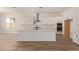 Spacious kitchen with center island, white cabinets, and stainless steel appliances at 15833 W Bronco Trl, Surprise, AZ 85387