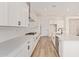 Open kitchen boasts white cabinets, subway tile backsplash, and stainless steel appliances at 15833 W Bronco Trl, Surprise, AZ 85387