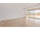 Bright living room with sliding glass doors and wood-look tile flooring at 15833 W Bronco Trl, Surprise, AZ 85387