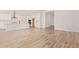 Open-concept living area with wood-look tile flooring adjacent to the kitchen at 15833 W Bronco Trl, Surprise, AZ 85387