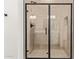 Glass shower door and beige tiled walls makes for a sleek and modern shower at 15833 W Bronco Trl, Surprise, AZ 85387