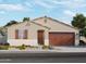 Charming single-story home with a two-car garage, desert landscaping, and a warm, inviting facade at 16004 W Honeysuckle Dr, Surprise, AZ 85387