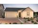Charming single-story home featuring a two-car garage and desert landscaping at 16448 W Whispering Wind Dr, Surprise, AZ 85387