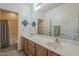 Bright bathroom boasts a double vanity, decorative accents, and updated gray wood-look flooring at 18174 E Via Jardin --, Gold Canyon, AZ 85118