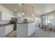 Spacious kitchen featuring white cabinets, a large island, modern appliances, and a dining area at 18174 E Via Jardin --, Gold Canyon, AZ 85118