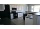 Contemporary kitchen featuring sleek appliances, dark countertops, and ample storage space at 18174 E Via Jardin --, Gold Canyon, AZ 85118