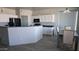 Open-concept kitchen with breakfast bar, white cabinetry, and modern appliances, adjacent to dining area at 18174 E Via Jardin --, Gold Canyon, AZ 85118