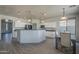 Bright kitchen with white cabinetry, pendant lighting, a large island, and stainless appliances at 18174 E Via Jardin --, Gold Canyon, AZ 85118