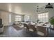 Bright living room featuring a marble dining table, sectional sofa, and large windows at 18174 E Via Jardin --, Gold Canyon, AZ 85118