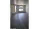 An expansive living room featuring new, gray wood-look flooring, neutral walls and abundant natural light at 18174 E Via Jardin --, Gold Canyon, AZ 85118