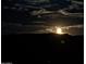 Night scene of the moon rising over a dark landscape with scattered clouds in the sky at 18174 E Via Jardin --, Gold Canyon, AZ 85118