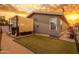 Backyard featuring turf, gravel, and a covered hot tub with sunset views at 201 S Greenfield Rd # 173, Mesa, AZ 85206