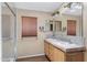Bathroom with double sinks, tile countertop, framed mirrors, and walk-in shower at 201 S Greenfield Rd # 173, Mesa, AZ 85206