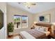 Inviting bedroom with a large window overlooking a view, complemented by warm, neutral decor at 201 S Greenfield Rd # 173, Mesa, AZ 85206