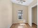Bright bedroom features wood laminate flooring, a ceiling fan, and a window at 201 S Greenfield Rd # 173, Mesa, AZ 85206