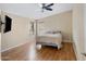Comfortable bedroom features a ceiling fan, light-colored walls, and wood laminate flooring at 201 S Greenfield Rd # 173, Mesa, AZ 85206