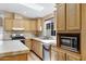 Beautiful kitchen featuring light wood cabinets, a skylight, and stainless steel appliances at 201 S Greenfield Rd # 173, Mesa, AZ 85206