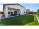 Outdoor living space includes artificial turf, covered patio with furniture, and privacy fencing at 27510 N 30Th Ln, Phoenix, AZ 85083