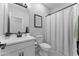 Bathroom with shower curtain, white cabinets and dark hardware at 27510 N 30Th Ln, Phoenix, AZ 85083
