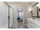 Modern bathroom showcasing a glass door shower, stylish tile floor, and double vanity sinks at 27510 N 30Th Ln, Phoenix, AZ 85083