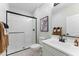Modern bathroom featuring a glass-enclosed shower, white subway tiles, and sleek black hardware fixtures at 27510 N 30Th Ln, Phoenix, AZ 85083