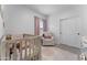 Cozy Bedroom with a crib, comfortable rocking chair, and soft pink accents for a serene atmosphere at 27510 N 30Th Ln, Phoenix, AZ 85083
