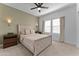 Serene bedroom featuring carpet, a ceiling fan, and a large window for lots of natural light at 27510 N 30Th Ln, Phoenix, AZ 85083