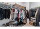 Walk-in closet featuring rods for hanging clothes, shelves, and lots of space for shoes at 27510 N 30Th Ln, Phoenix, AZ 85083