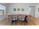 Bright dining room with wood-look tile floors and a long wood table with gray chairs at 27510 N 30Th Ln, Phoenix, AZ 85083