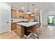 Modern kitchen featuring stainless appliances, island seating, and wood-look flooring at 27510 N 30Th Ln, Phoenix, AZ 85083