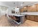 Well-lit kitchen features stainless steel appliances, island with bar stools, and wood-look floors at 27510 N 30Th Ln, Phoenix, AZ 85083