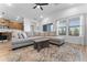 Inviting living room featuring a comfortable sectional sofa, ceiling fan, and large windows at 27510 N 30Th Ln, Phoenix, AZ 85083