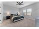 Calm main bedroom with a ceiling fan, two windows, carpeted floor, and two side tables at 27510 N 30Th Ln, Phoenix, AZ 85083