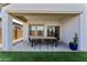Comfortable covered patio with dining table, chairs, and desert landscaping for outdoor living at 27510 N 30Th Ln, Phoenix, AZ 85083