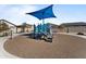 Community playground with vibrant blue equipment and covered picnic area at 27510 N 30Th Ln, Phoenix, AZ 85083