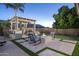 Inviting backyard patio features a built-in grill, a pergola, a fire pit and comfortable outdoor seating at 3237 E Park Ave, Gilbert, AZ 85234