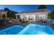 Inviting backyard with pool, lounge area, and fire pit offers a perfect space for relaxation and entertainment at 3237 E Park Ave, Gilbert, AZ 85234