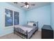 Cozy bedroom with a wrought iron bed frame and bright, blue walls at 3237 E Park Ave, Gilbert, AZ 85234