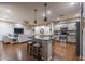 Open concept kitchen with center island, stainless steel appliances, and hardwood floors create a seamless living space at 3237 E Park Ave, Gilbert, AZ 85234