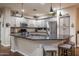 Stylish kitchen featuring granite countertops, stainless steel appliances, and a breakfast bar for casual dining at 3237 E Park Ave, Gilbert, AZ 85234