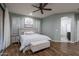 Charming main bedroom featuring hardwood floors, a ceiling fan, and a stylish ensuite bathroom offers comfort at 3237 E Park Ave, Gilbert, AZ 85234