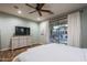 Serene main bedroom with hardwood floors, backyard views, and a ceiling fan creates a tranquil atmosphere at 3237 E Park Ave, Gilbert, AZ 85234