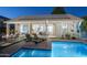 Inviting backyard pool with lounge chairs and solar panels on the home's roof for energy efficiency at 3237 E Park Ave, Gilbert, AZ 85234