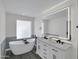 Bathroom with a sleek, modern tub and stylish vanity with illuminated mirror and black fixtures at 3401 N 37Th St # 14, Phoenix, AZ 85018