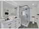Modern bathroom features double sinks, stylish illuminated mirror, and frameless glass shower at 3401 N 37Th St # 14, Phoenix, AZ 85018